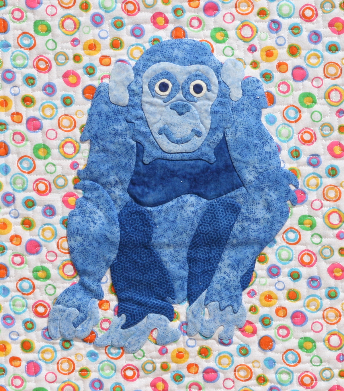 Blue Chimp on a colorful background fabric appliqué quilt pattern