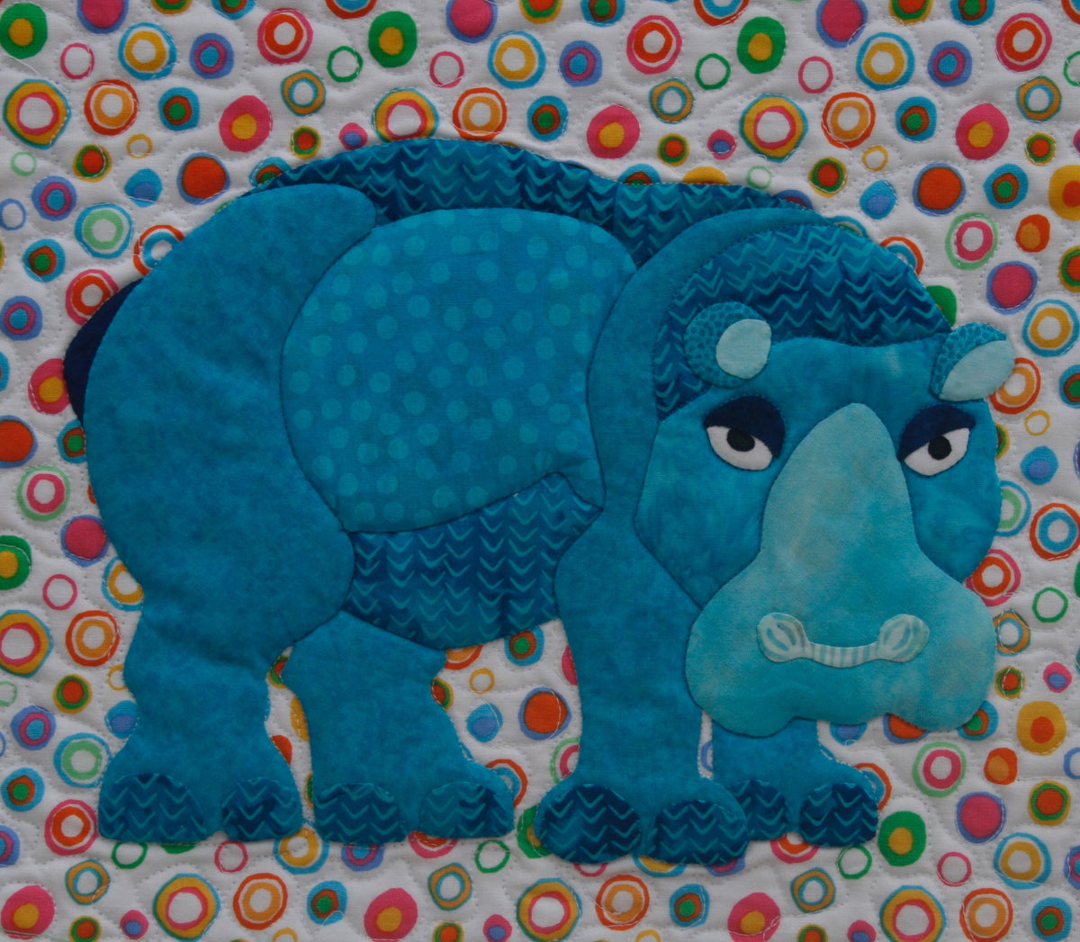 Blue Hippo on a colorful background fabric appliqué quilt pattern